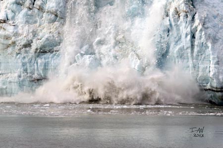 A glacier breaking apart and falling into the water